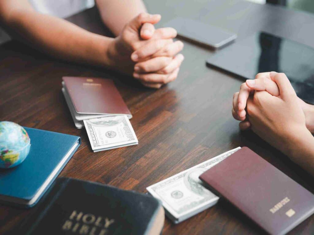 Mission trip fundraising - image showing Christians praying with their passports next to them