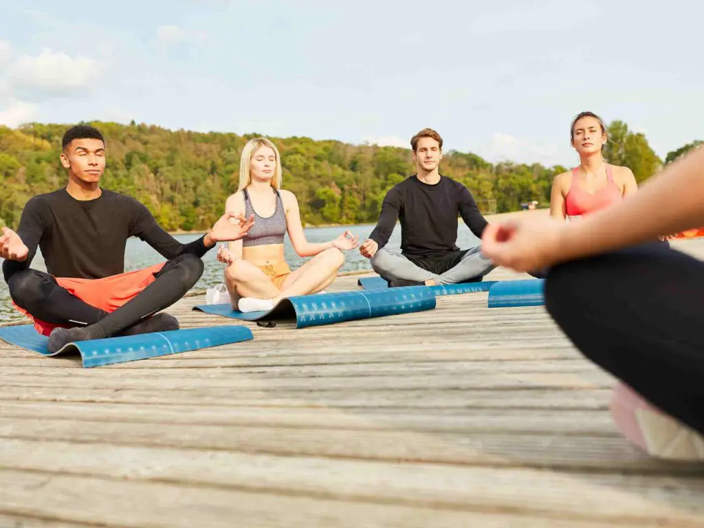 people at an outdoor yoga event